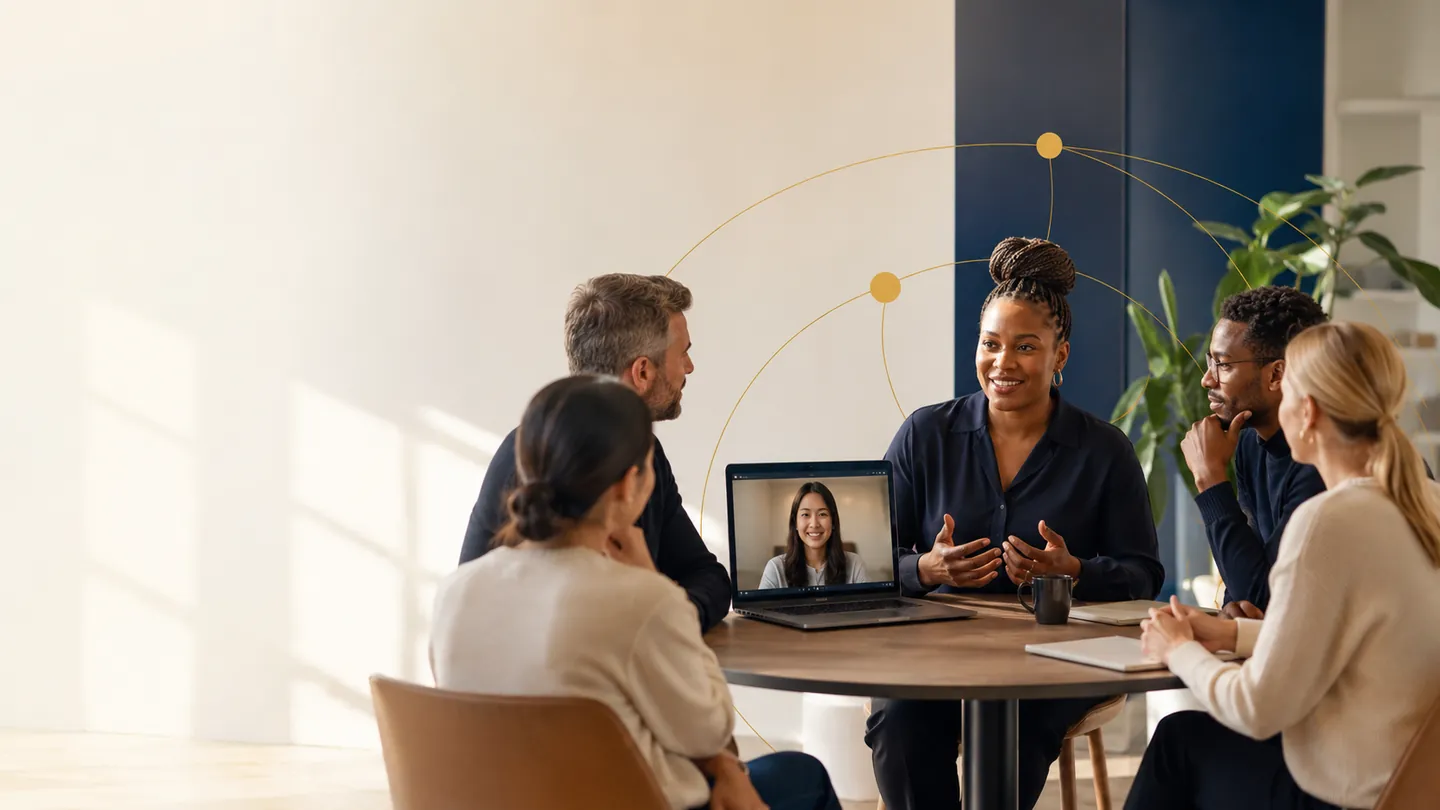 A group of clinical research professionals in a membership discussion around a table, with a colleague joining by video call